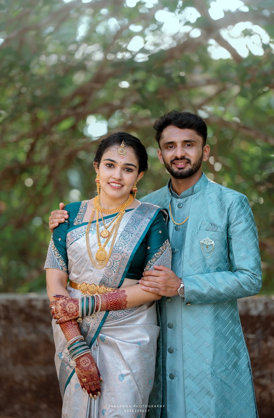 Dr. Manisha M and Dr. Pawan Kumar B in engagement attire under a tree